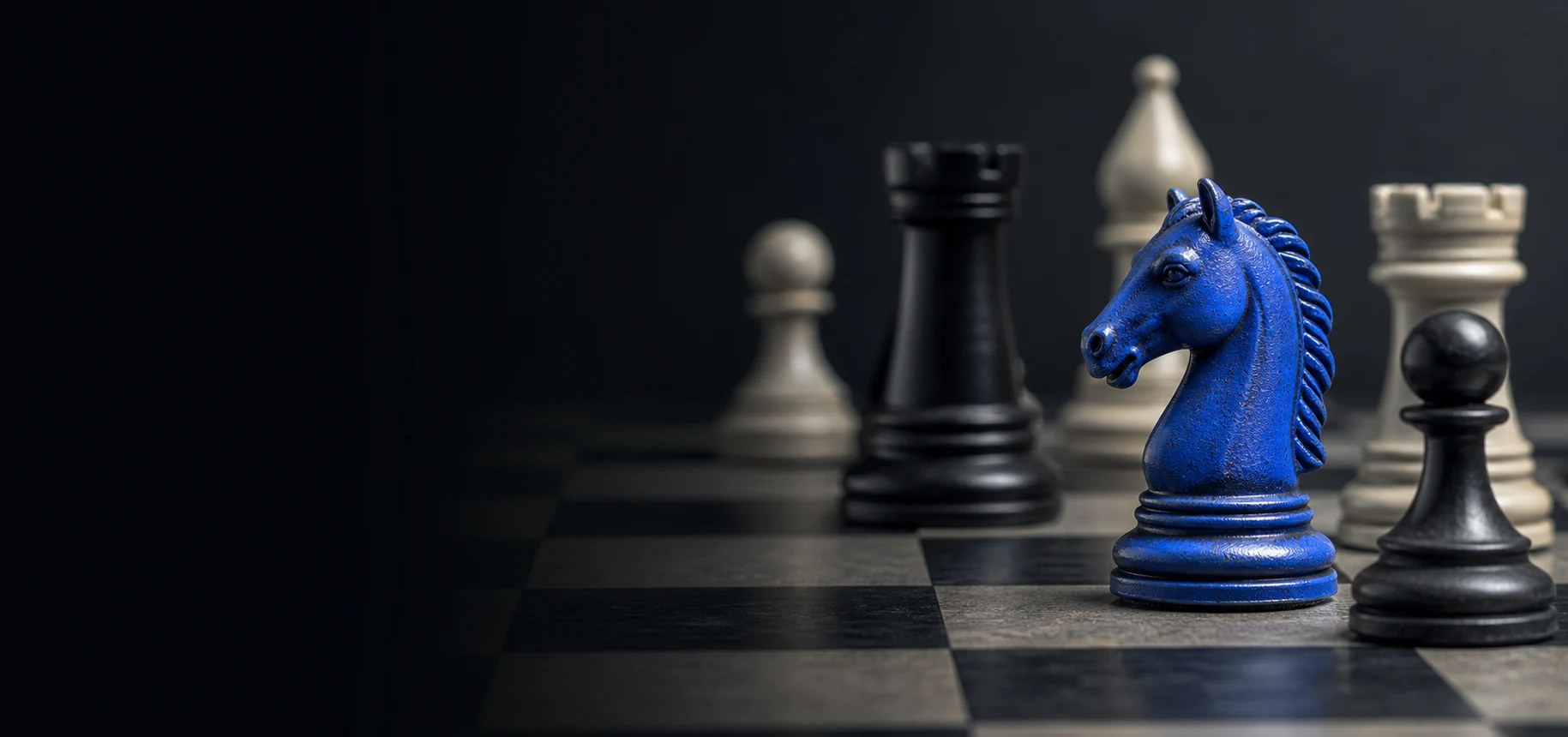 A dark chessboard with a cobalt-blue knight among black and ivory pieces